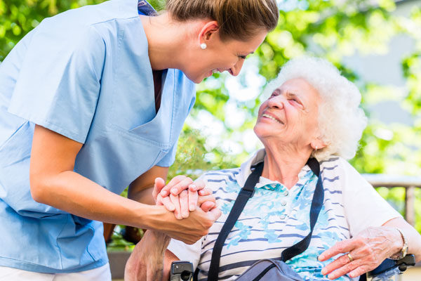 nurse and patient smiling at each other